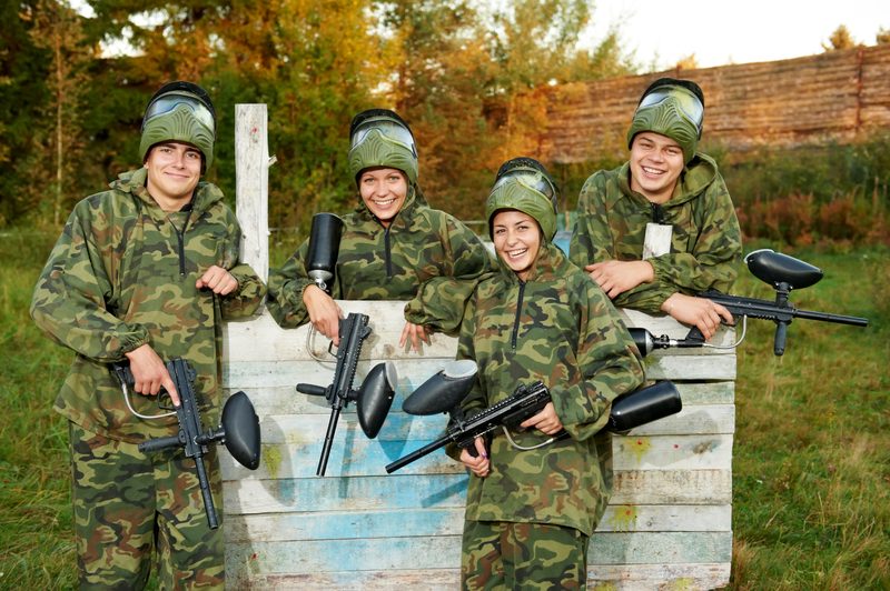 A corporate group playing paintball