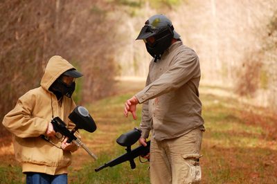 Paintball players on the field in wet weather